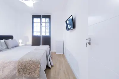Cama o camas de una habitación en Las Palmas Smart Rooms