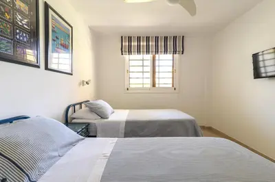 Cama o camas de una habitación en Apartamento junto a la playa