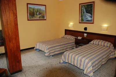 Cama o camas de una habitación en Hotel Olympia