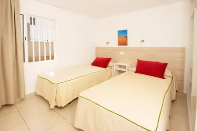 Cama o camas de una habitación en Apartamentos Cocoteros
