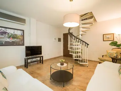 Una televisión o centro de entretenimiento en City Family Tomas Miller