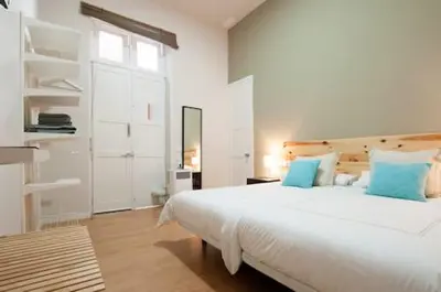 Cama o camas de una habitación en Triana 103 Rooms & Suites