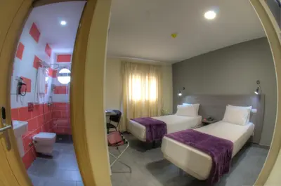 Cama o camas de una habitación en Hotel Puerto Canteras