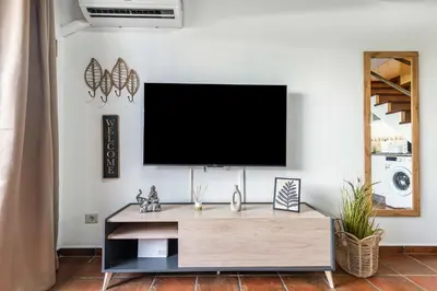 Una televisión o centro de entretenimiento en Paradise Dunas Maspalomas