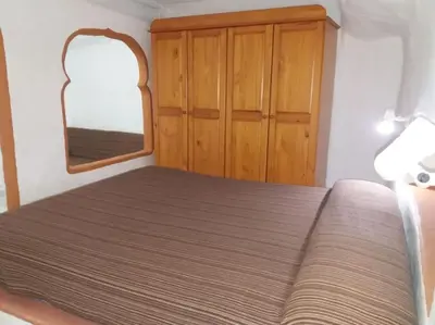 Cama o camas de una habitación en Casa cueva primera línea playa