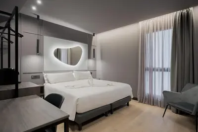 Cama o camas de una habitación en Hotel LIVVO La Escarlata