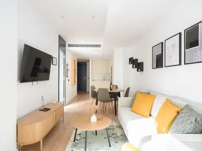 Una televisión o centro de entretenimiento en Apartamento con Gimnasio cerca playa de Las Canteras D3A