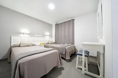Cama o camas de una habitación en Apartamentos Los Papagayos