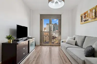 Una televisión o centro de entretenimiento en Home2Book Bright City Apartment Las Palmas