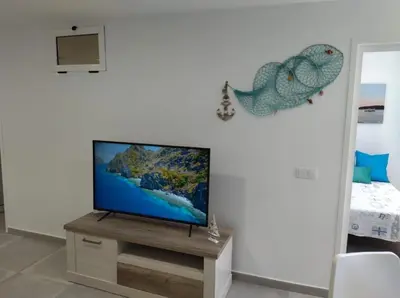 Una televisión o centro de entretenimiento en Seaside Aguila Playa 326