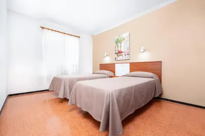 Cama o camas de una habitación en Apartamentos las Góndolas