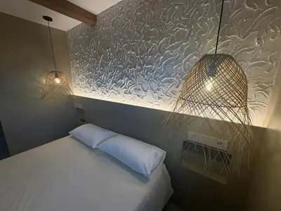 Cama o camas de una habitación en Precioso apartamento de playa con jardín privado