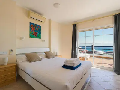 Cama o camas de una habitación en La Gloria Villas San Agustin