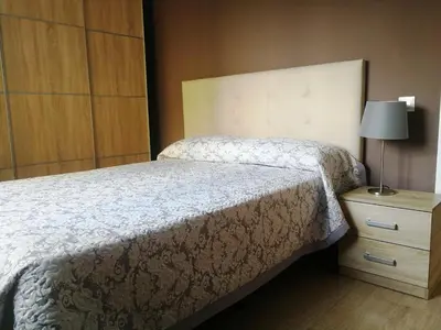 Cama o camas de una habitación en HUELLA CANARIA Complejo LAS OLAS