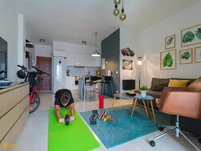 Una televisión o centro de entretenimiento en Living Las Canteras Homes - WORKOUT & FREE BIKES