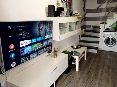 Una televisión o centro de entretenimiento en Maspalomas Bungalow C I