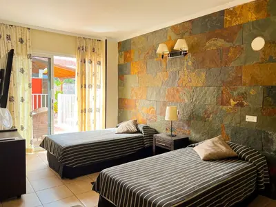 Cama o camas de una habitación en Hotel La Aldea Suites