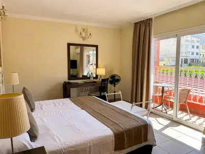 Cama o camas de una habitación en Hotel La Aldea Suites
