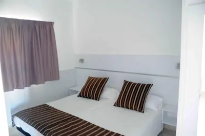 Cama o camas de una habitación en Bungalows Los Arcos