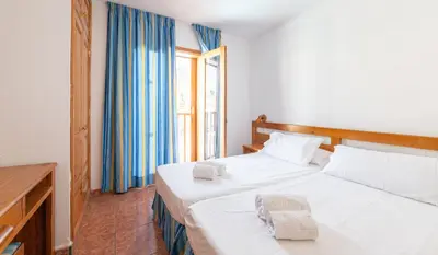 Cama o camas de una habitación en Ura Hotels Apartamentos Montecarlo