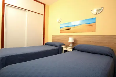 Cama o camas de una habitación en Apartamentos Strelitzias