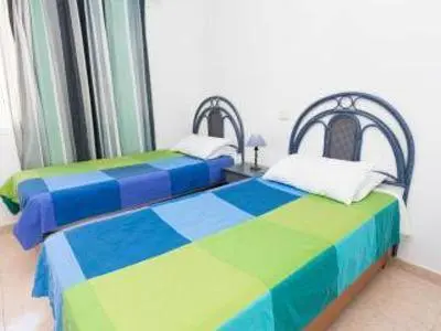 Cama o camas de una habitación en Apartamentos Ernesto