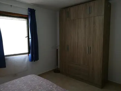 Cama o camas de una habitación en Arinaga Beach & Pool Apartment