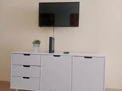 Una televisión o centro de entretenimiento en Las Olas Mar