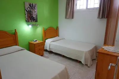 Cama o camas de una habitación en Apartamentos Ecuador