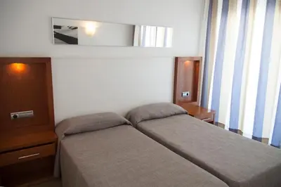 Cama o camas de una habitación en Apartamentos Cabau Altair