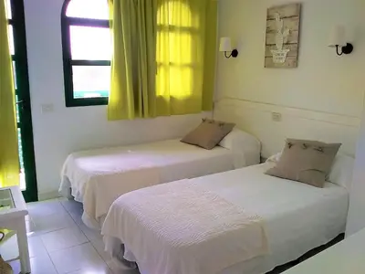Cama o camas de una habitación en Bungalow Duna Flor Maspalomas