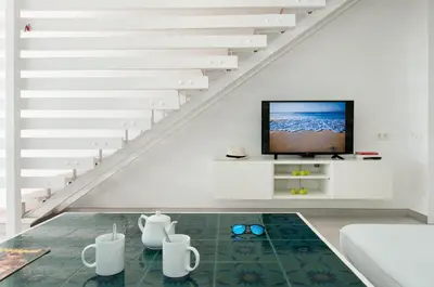 Una televisión o centro de entretenimiento en Beachfront Apartment Las Burras FA03 by VillaGranCanaria