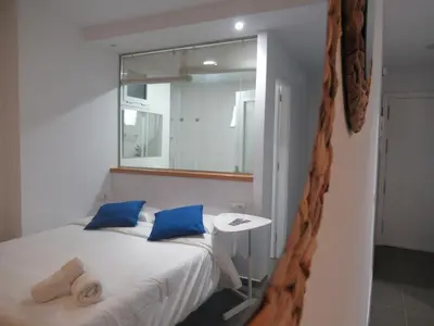 Cama o camas de una habitación en Vivelorural estudio Las Canteras vista mar- 308