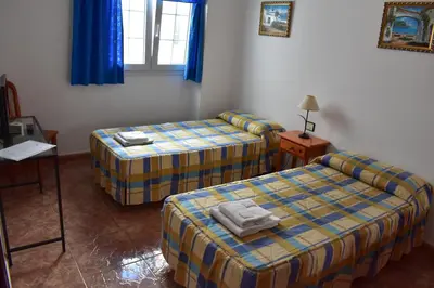 Cama o camas de una habitación en La Fonda Aeropuerto
