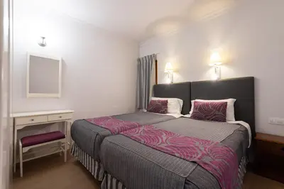 Cama o camas de una habitación en TC Apartamentos Don Diego