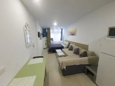 Una televisión o centro de entretenimiento en Playa de Las Canteras & Puerto Loft
