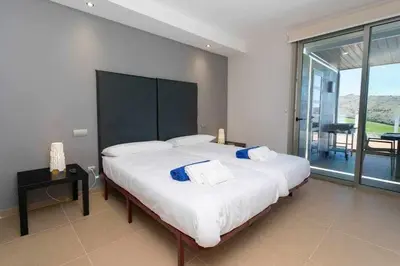 Cama o camas de una habitación en Villa Los Dragos Golf by Infinity Summer