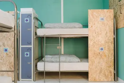 Cama o camas de una habitación en KYO Surf Hostel