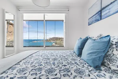 Cama o camas de una habitación en Home2Book Blue Sea View Patalavaca Beach Apartment