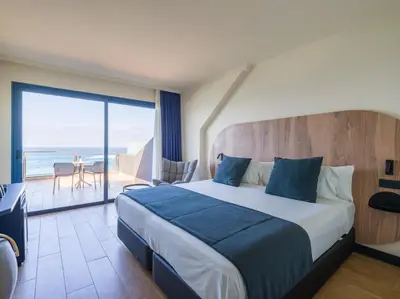 Cama o camas de una habitación en Sercotel Playa Canteras