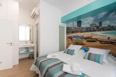 Cama o camas de una habitación en Petit Accommodation Las Canteras Premier